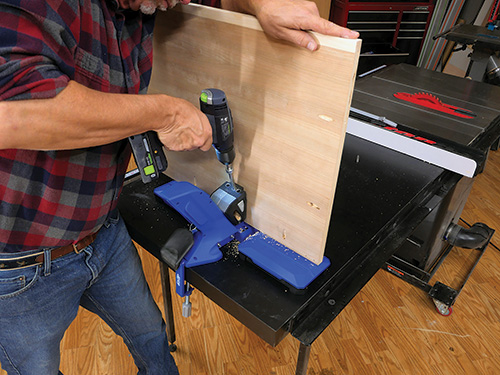 Using Kreg jig to drill pocket holes in sewing cabinet joints