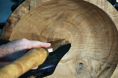 Shear-scraping the inside of a bowl with a gouge