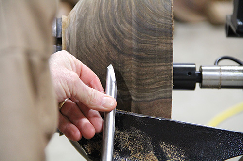 Scraping a bowl with a gouge