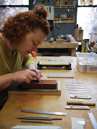 Teresa Audet working with marking knife