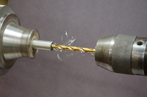 Drilling through metal rod center