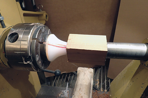 Setting turning blank against collet chuck