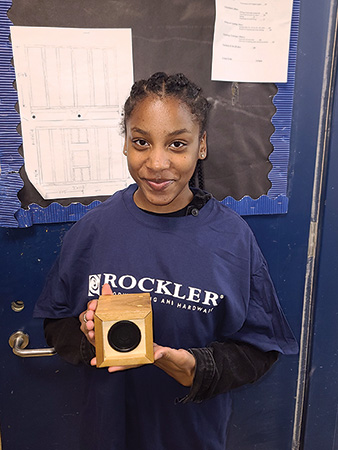 Student displaying her completed speaker