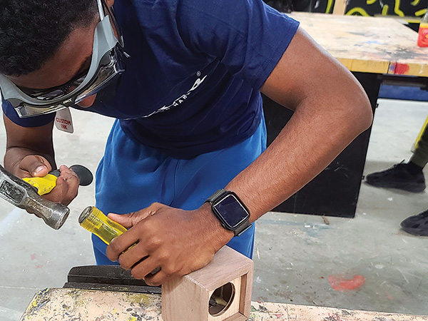 Student working on Bluetooth speaker casework