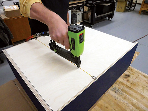Attaching bookcase back panel with a nail gun