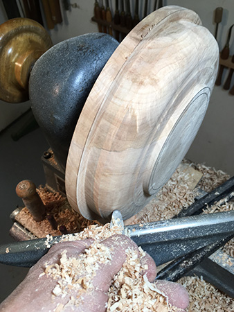 Using roundnose scraper to begin shaping bowl