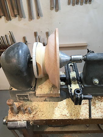 Bowl blank and mounting block on lathe