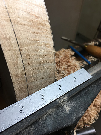 Marking side of bowl blank to create bowl's rim