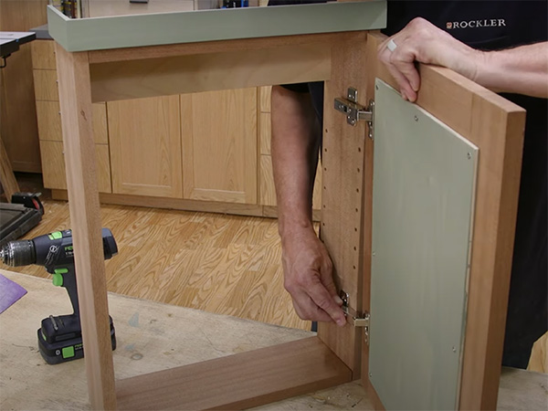 Fitting door panel on wall cabinet