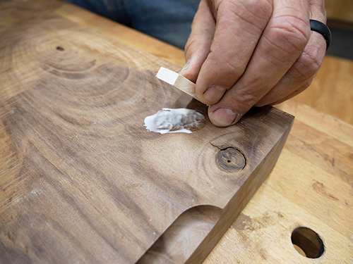 Gluing feet onto the base of serving tray