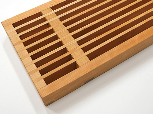 Close-up of slats on cherry shelving