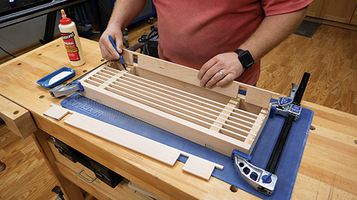 Gluing cherry shelf slats in place