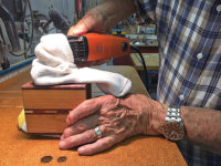 Applying paste wax with a sock and multi-tool