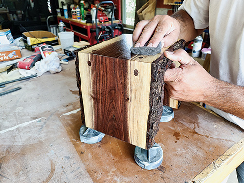 Rubbing down finished table with steel wool