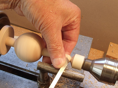 Preparing to cut off turned spoon handle