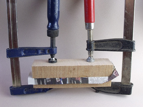 Gluing together spoon blanks around newspaper