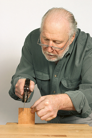 Hand sawing dovetail tails in desk drawer