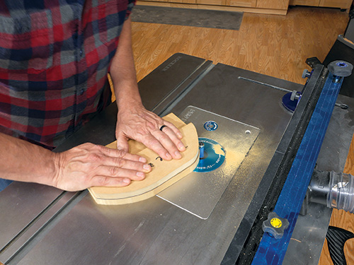 Routing edges of glued together coat hook blank with flush-trim bit