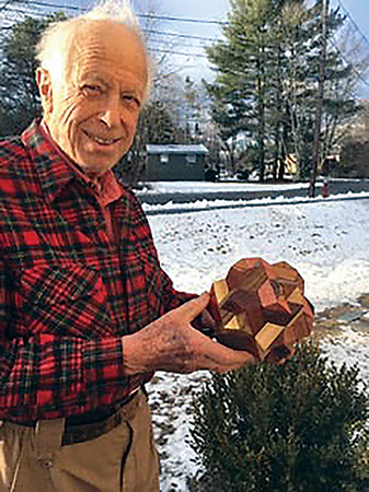 Stewart Coffin showing off one of his wood puzzles