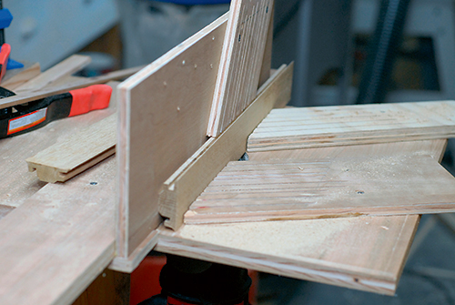 After routing the leg sides’ edges, reposition your featherboards and rout the faces with the show side of the boards facing away from the table.