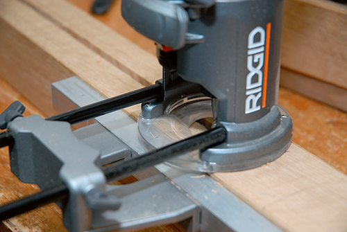 An edge guide positions the router for plowing grooves for the corbels. Or, mill these long grooves on the router table against a fence, if you prefer.