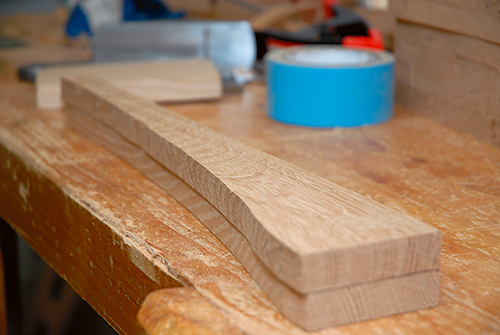 flush-cut bit trims the corbels to final shape. Double-sided tape attaches the pattern to the work and the work to the benchtop.
