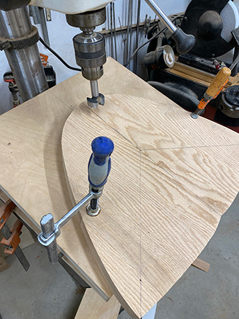 Securing stool blank to drill press jig with clamp