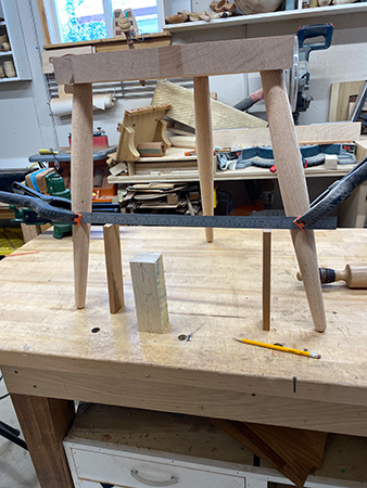 Clamping stool legs together to prepare for drilling stretcher holes