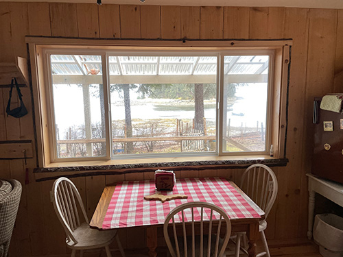 Large cabin window made with slab wood