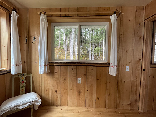 Small cabin window made with slab wood