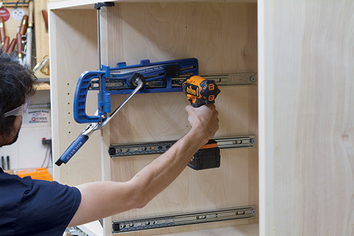 Using drawer slide jig to install slides in outfeed table