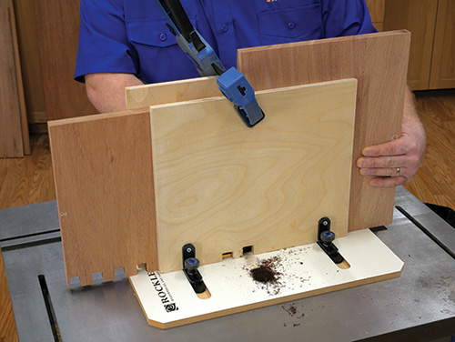 Panel clamped in router box joint jig