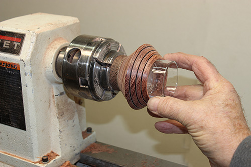 Placing tealight glass in candleholder turning