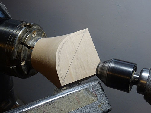 Box blank mounted in lathe with cut lines in pencil