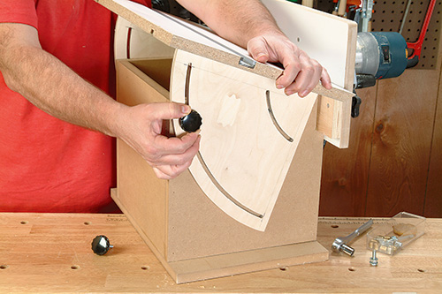 Adding hand screws to threaded insert in tilting router table top