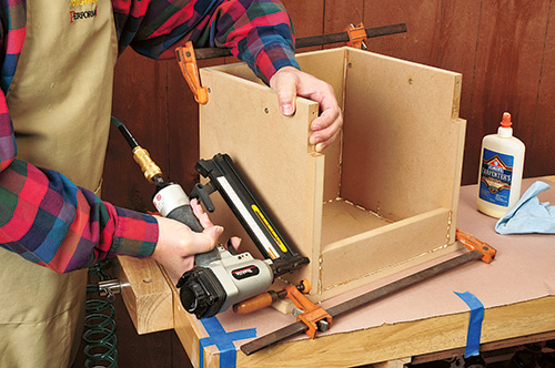 Using a nail gun to attach router table base parts
