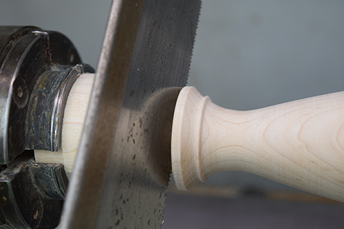 Using hand saw to cut toothpick holder from blank