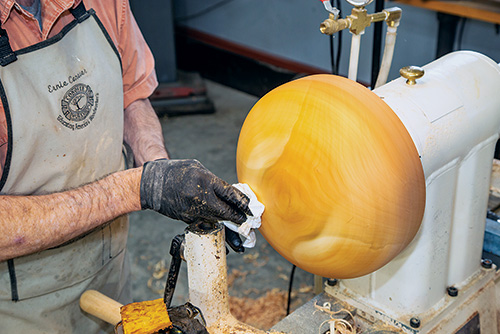 Finishing sanded area of calabash turning