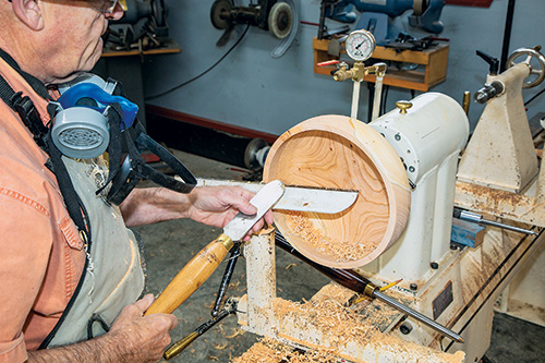 Scraping interior of calabash bowl turning