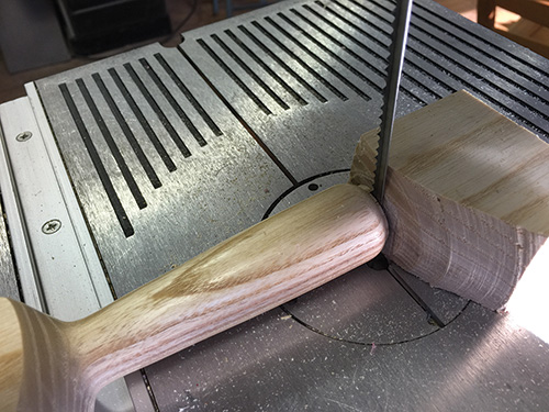 Removing waste from bread knife handle with band saw