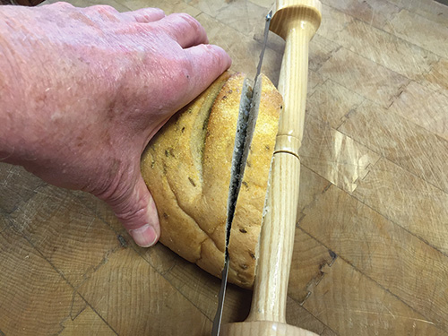 Testing turned bread knife by cutting slice