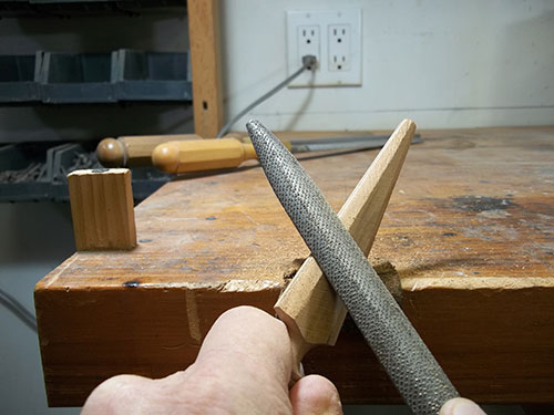 Using rasp to sharpen wooden knife blade