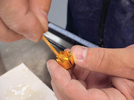 Adding epoxy glue to interior of ornament hardware