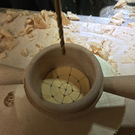 Drilling strainer holes in cup