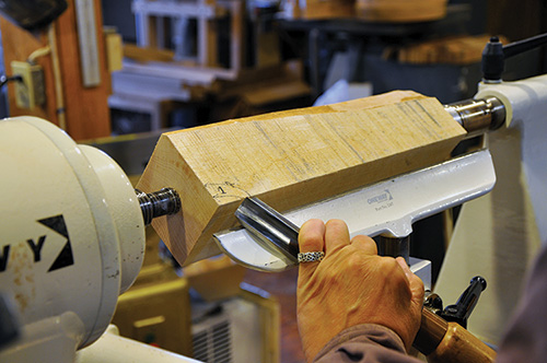 Setting up to begin turning mallet with roughing gouge