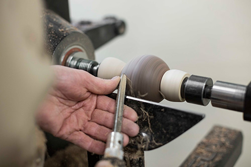 Making shear-scraping cuts on ball mounted on a lathe