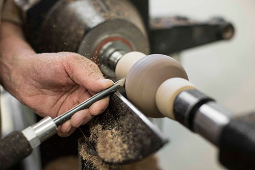 Making downward shearing cuts on a turned sphere