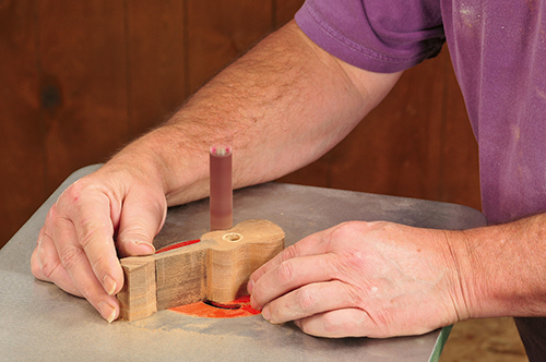 An oscillating spindle sander is the ideal tool for quickly removing saw marks and smoothing the log’s concave edges.