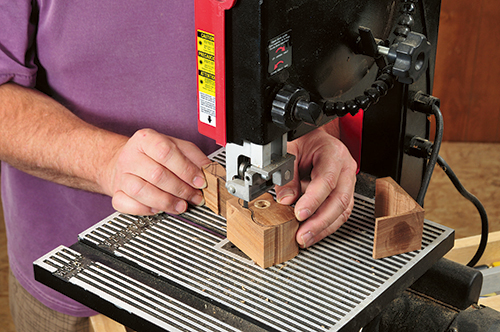 A narrow blade in the band saw is used to cut the uke log to final shape.