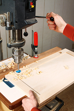 Boring hole in miter saw stand door with drill press for cup hinge